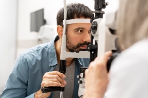 Optometrist conducting an eye exam with a slit lamp biomicroscope, assessing patient's vision and overall eye health in a state-of-the-art ophthalmology clinic. Medical concept